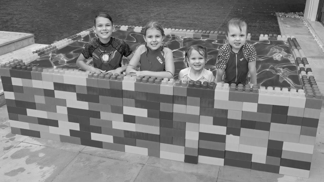 Five Kids The way to Swim in the Youngsters Pool and Plays with Fun Water Toys